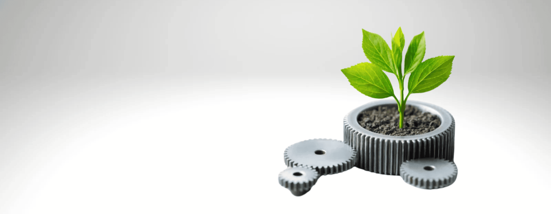 Plant growing in mechanical gear - symbolizing sustainable manufacturing